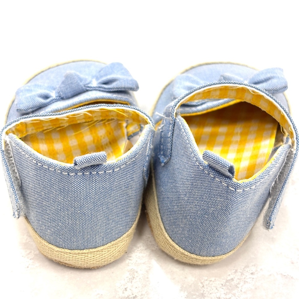 Baby’s blue denim shoes with bows and yellow gingham print